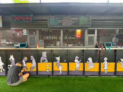 The Zoomies bar with neon sign and dog mural